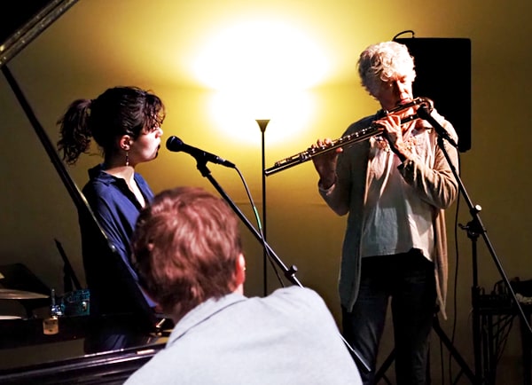 Bass flute and voice interlude with student's listening for now and what's next.