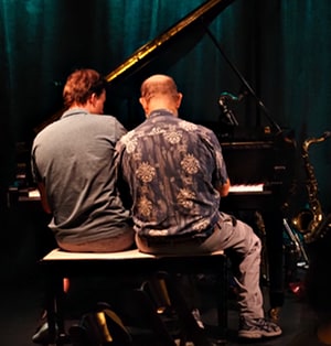 Art and student at the piano