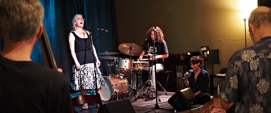 Students on stage exploring improv in the round